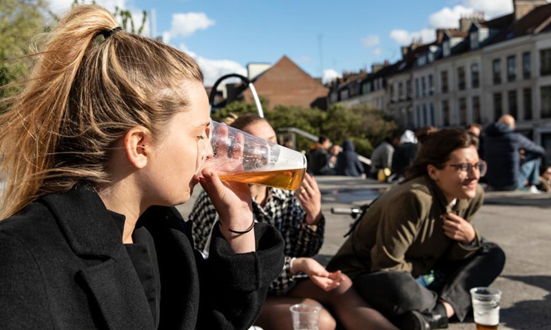 People drink and chat in Lille, northern France, May 19, 2021. France on Wednesday took an important step forward towards returning to normality as people in the country can once again meet up in cafes or enjoy a meal in restaurants, which are now allowed to open their terraces.(Photo:Xinhua) 