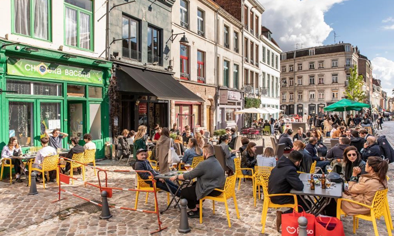 People are seen at a terrace of a bar in Lille, northern France, May 19, 2021. France on Wednesday took an important step forward towards returning to normality as people in the country can once again meet up in cafes or enjoy a meal in restaurants, which are now allowed to open their terraces.(Photo:Xinhua) 