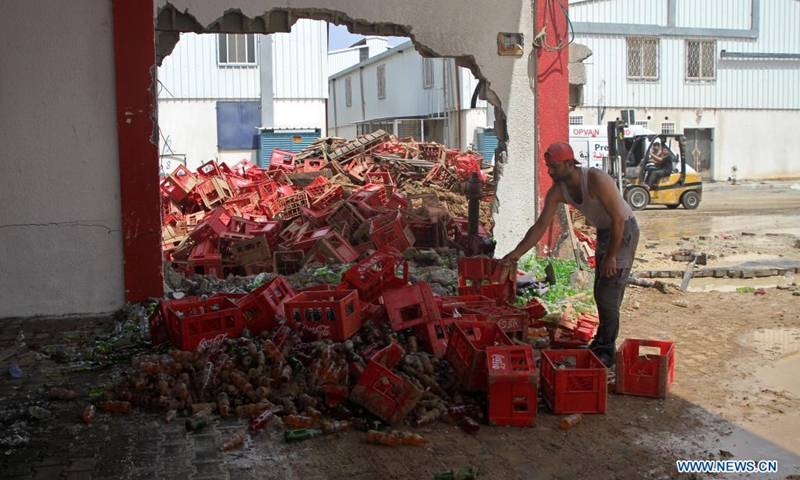 A Palestinian inspects the debris of a factory following an Israeli air strike in the Karni industrial zone, east of Gaza City, on May 21, 2021. An Egyptian-brokered ceasefire agreement came into effect early on Friday between Israel and Hamas, which rules the Gaza Strip, ending the 11-day bloodshed.(Photo: Xinhua)