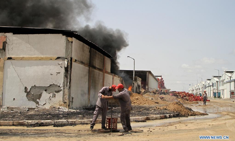 Palestinians inspect the debris of a factory following an Israeli air strike in the Karni industrial zone, east of Gaza City, on May 21, 2021. An Egyptian-brokered ceasefire agreement came into effect early on Friday between Israel and Hamas, which rules the Gaza Strip, ending the 11-day bloodshed.(Photo: Xinhua)