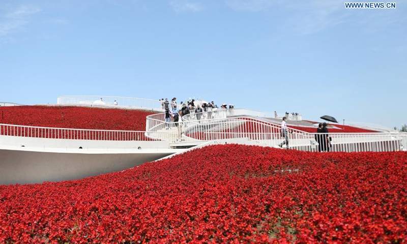 People visit the 10th China Flower Expo in east China's Shanghai, May 21, 2021. The 10th China Flower Expo opened here on Friday, welcoming over 20,000 visitors on its first day. The expo, held to showcase the development of China's flower industry, will last until July 2. A total of 180 outdoor exhibition zones and 64 indoor areas have been set up at the expo park in the city's Chongming District.(Photo: Xinhua)