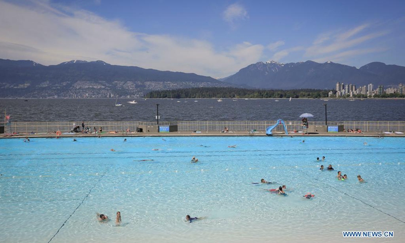 People go swimming on the first day of re-opening at the Kitsilano outdoor pool in Vancouver, British Columbia, Canada, May 22, 2021. Three of Vancouver's outdoor pools reopened Saturday. Due to the COVID-19 registration in place, anyone who wants to take a dip will have to register in advance due to pandemic-related restrictions on capacity.(Photo: Xinhua)
