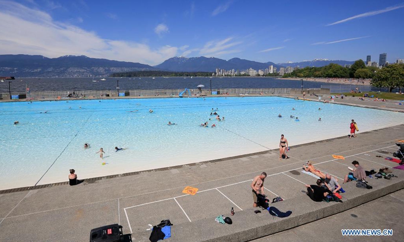 People go swimming on the first day of re-opening at the Kitsilano outdoor pool in Vancouver, British Columbia, Canada, May 22, 2021. Three of Vancouver's outdoor pools reopened Saturday. Due to the COVID-19 registration in place, anyone who wants to take a dip will have to register in advance due to pandemic-related restrictions on capacity.(Photo: Xinhua)