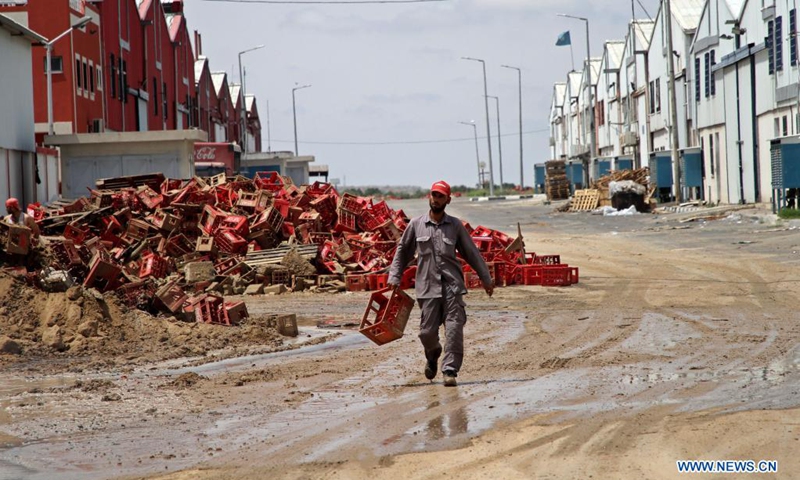 A Palestinian inspects the debris of a factory following an Israeli air strike in the Karni industrial zone, east of Gaza City, on May 21, 2021. An Egyptian-brokered ceasefire agreement came into effect early on Friday between Israel and Hamas, which rules the Gaza Strip, ending the 11-day bloodshed.(Photo: Xinhua)