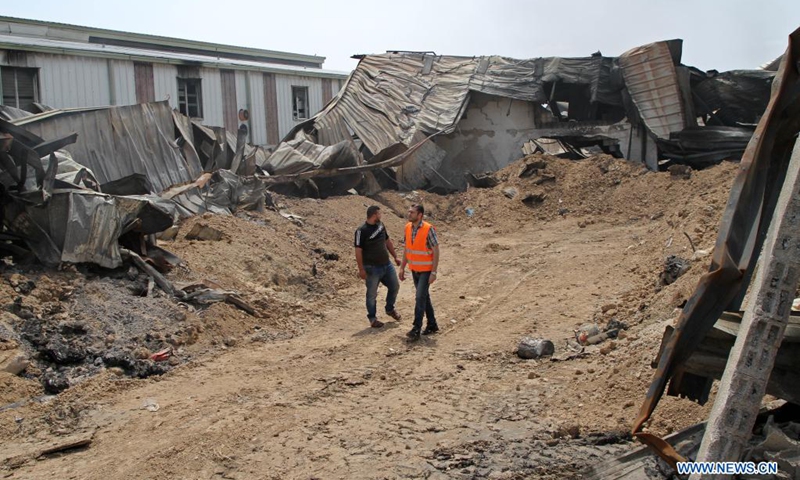 Palestinians inspect the debris of a factory following an Israeli air strike in the Karni industrial zone, east of Gaza City, on May 21, 2021. An Egyptian-brokered ceasefire agreement came into effect early on Friday between Israel and Hamas, which rules the Gaza Strip, ending the 11-day bloodshed.(Photo: Xinhua)