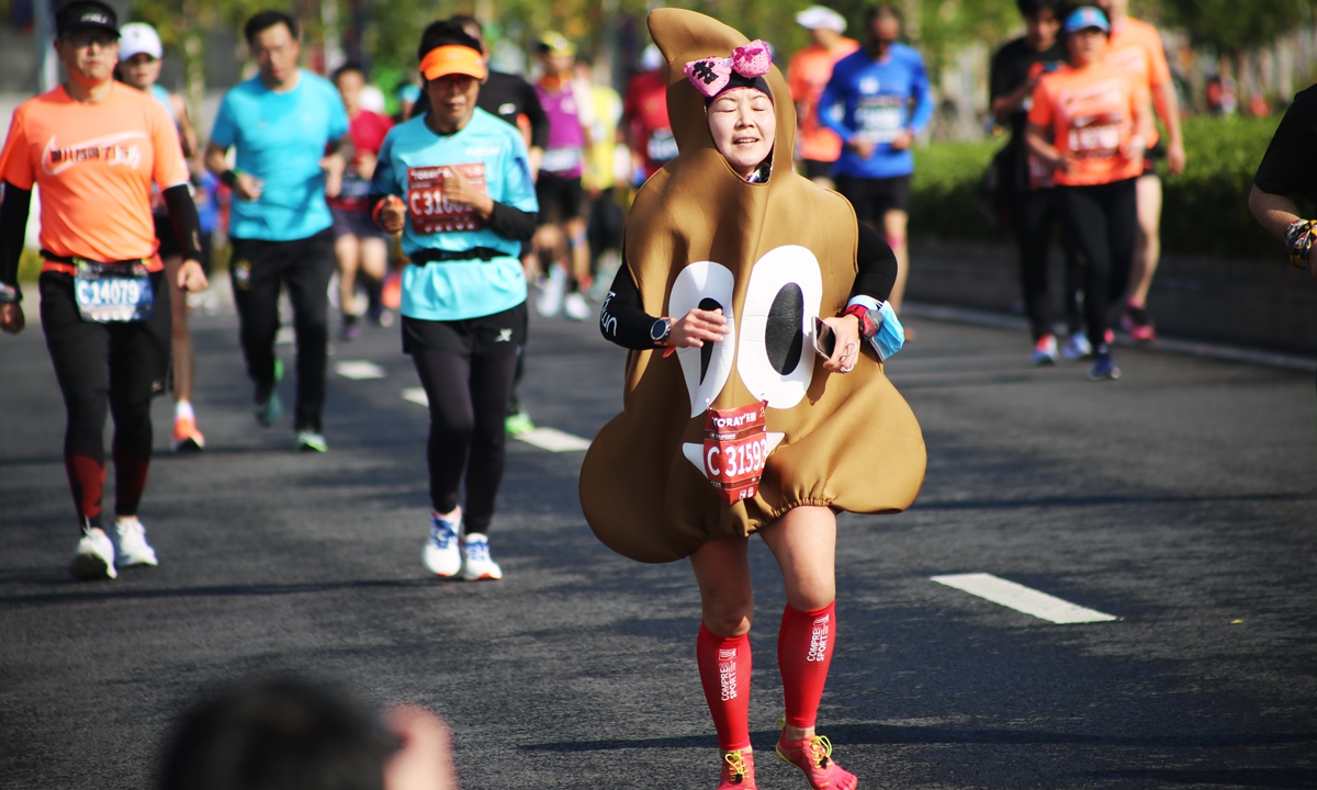 A woman dressed as a popular emoji runs during Shanghai marathon in November 2020. Photo: IC 