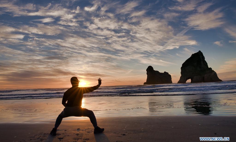 A visitor practises Chinese martial arts at the Wharariki Beach of the Golden Bay tourist site in New Zealand, May 23, 2021. (Photo: Xinhua)