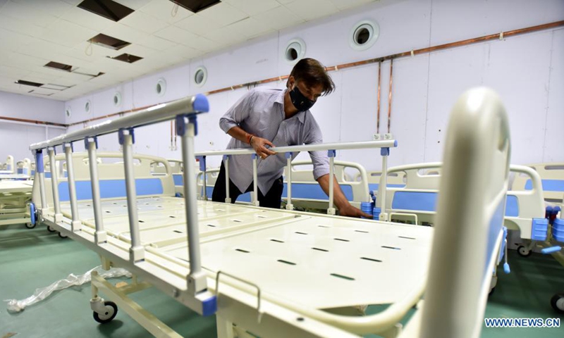 A worker installs beds at a 500-bed COVID-19 hospital in Jammu, the winter capital of Indian-controlled Kashmir, May 24, 2021. (Str/Xinhua)