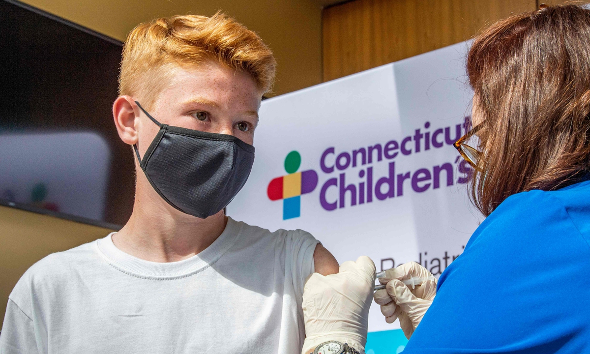 Robert Riccoban, age 13, is inoculated by Nurse Karen Pagliaro at Hartford Healthcare's mass vaccination center at the Connecticut Convention Center in Hartford, Connecticut on May 13, 2021. Photo: VCG
