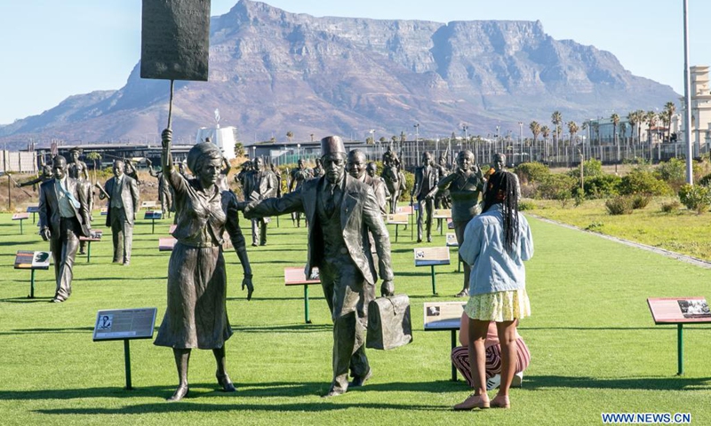 Visitors look at bronze statues at a tourist spot named the Long March to Freedom in Cape Town, South Africa on May 23, 2021. The Long March to Freedom has life-size bronze statues of 100 people who struggled for South Africa's freedom from the early 1700s to Freedom Day in April 1994. (Photo: Xinhua)