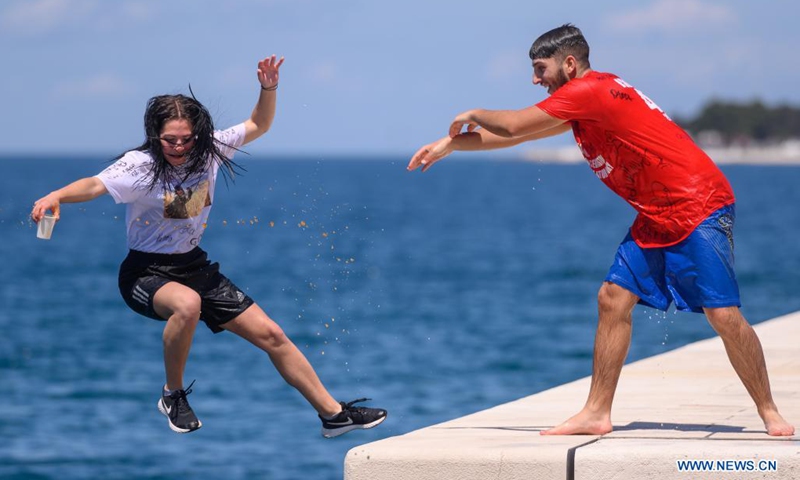 A secondary school student is pushed into the sea to celebrate the end of a school year in Zadar, Croatia, on May 25, 2021. The celebration of Norijada (Crazy Day) is held annually nationwide in Croatia to mark the end of a school year.(Photo: Xinhua)