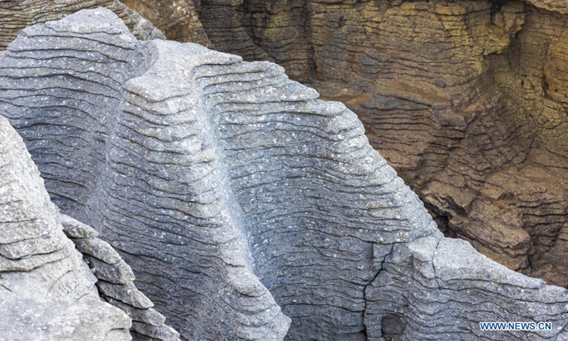Photo taken on May 25, 2021 shows a view of the Pancake Rocks in Punakaiki on the West Coast of the South Island, New Zealand. The Pancake Rocks were formed from minute fragments of dead marine creatures and plants landed on the seabed. (Photo by Zhang Jianyong/Xinhua)