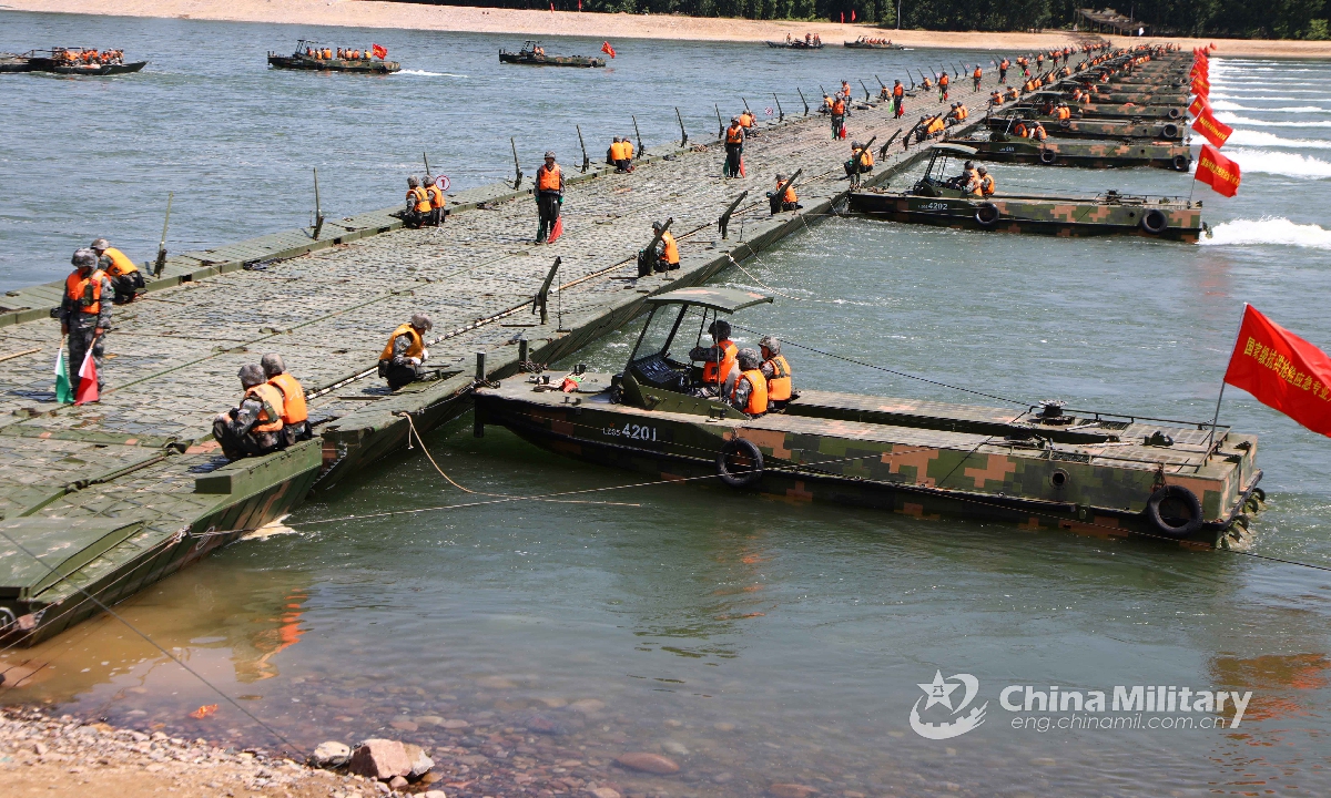 Propulsion boats attached to the pontoon element of a brigade under the PLA 83th Group Army pull together sections of a floating bridge system during a field support drill on May 20, 2021. (eng.chinamil.com.cn/Photo by Jia Fangwen)