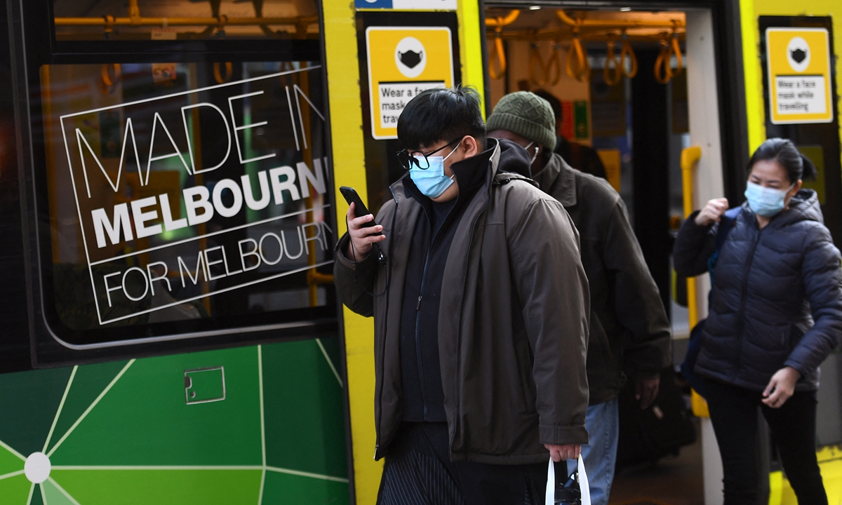 People wearing masks alight from a tram in Melbourne on Wednesday, as Australia's second biggest city scrambles to contain a growing COVID-19 outbreak. The country has reported more than 30,000 infections, with about 910 people dying from the deadly disease. Photo: AFP