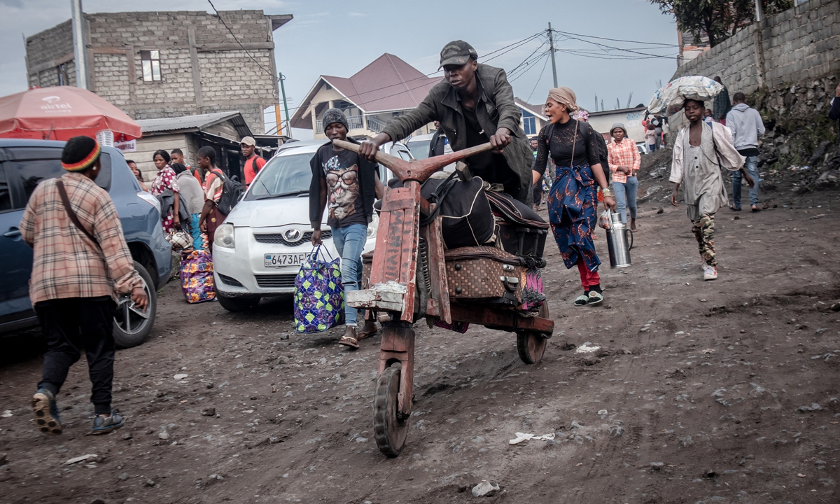 A man carries luggage on a traditional wooden bicycle for residents fleeing Goma after an evacuation order has been given on Thursday. The authorities in Goma, in the east of the Democratic Republic of the Congo, ordered the evacuation of part of the city due to the risk of eruption of the Nyiragongo volcano. Photo: AFP