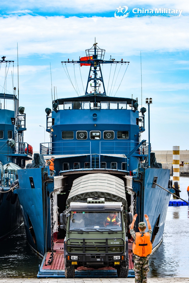 Soldiers assigned to a brigade of the PLA 73rd Group Army guides a military truck to pull out of a military RO-RO ferry vessel during a loading-unloading training exercise from May 18 to 21, 2021. (eng.chinamil.com.cn/Photo by Lin Jiayu) 