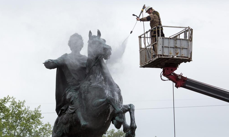 A worker cleans the bronze statue of Peter the Great, the founder of St. Petersburg, in preparation for the celebration of the 318th anniversary of the founding of the city, in St. Petersburg, Russia, on May 26, 2021. (Photo by Irina Motina/Xinhua)