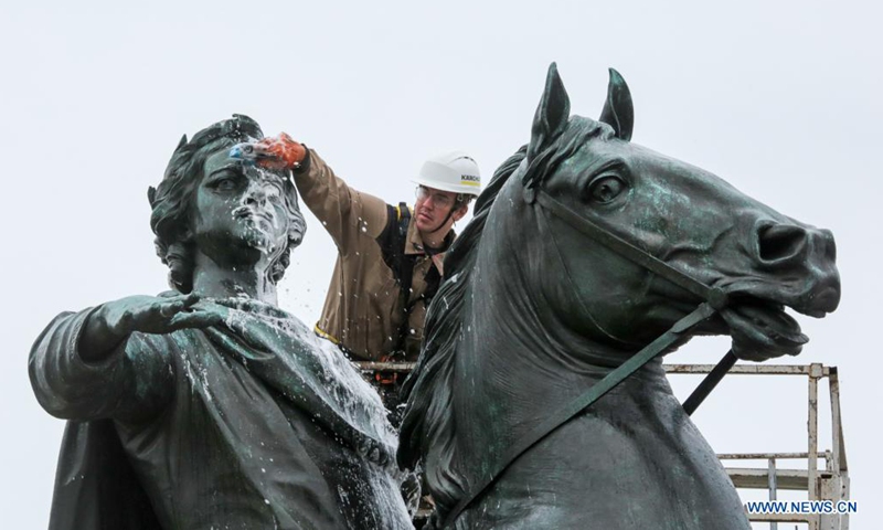 A worker cleans the bronze statue of Peter the Great, the founder of St. Petersburg, in preparation for the celebration of the 318th anniversary of the founding of the city, in St. Petersburg, Russia, on May 26, 2021. (Photo by Irina Motina/Xinhua)