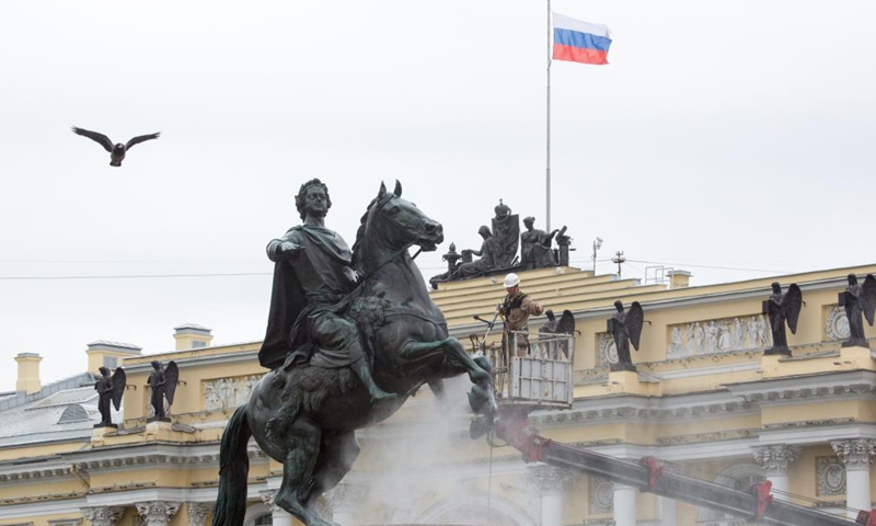 A worker cleans the bronze statue of Peter the Great, the founder of St. Petersburg, in preparation for the celebration of the 318th anniversary of the founding of the city, in St. Petersburg, Russia, on May 26, 2021. (Photo by Irina Motina/Xinhua)
