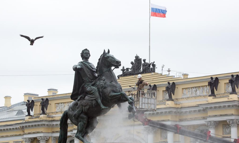 A worker cleans the bronze statue of Peter the Great, the founder of St. Petersburg, in preparation for the celebration of the 318th anniversary of the founding of the city, in St. Petersburg, Russia, on May 26, 2021. (Photo by Irina Motina/Xinhua)

