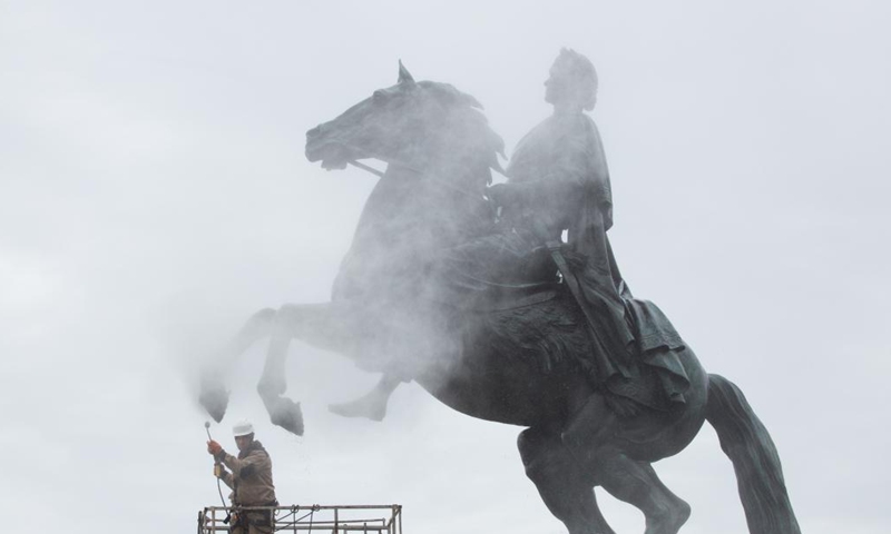 A worker cleans the bronze statue of Peter the Great, the founder of St. Petersburg, in preparation for the celebration of the 318th anniversary of the founding of the city, in St. Petersburg, Russia, on May 26, 2021. (Photo by Irina Motina/Xinhua)