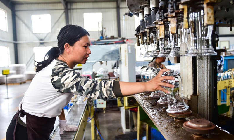 A worker makes glassware in Qixian County, north China's Shanxi Province, May 26, 2021. Glassware made in Qixian County has been exported to over 80 countries and regions.Photo:Xinhua