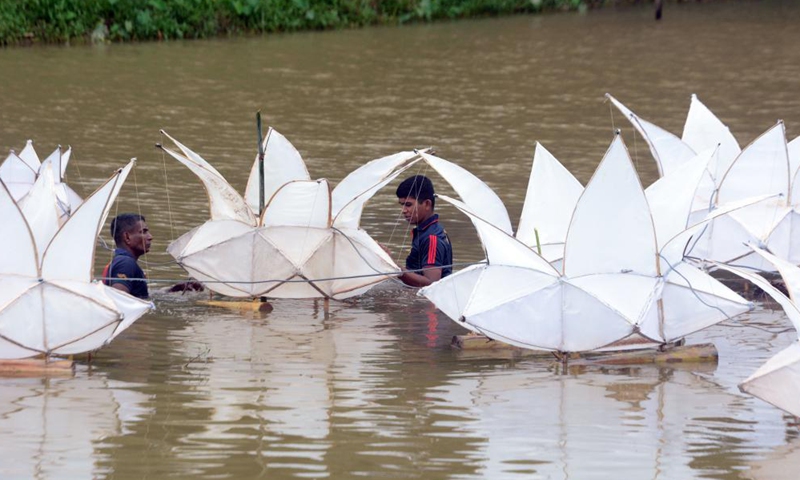People install lantern decorations for the Vesak festival in Colombo, Sri Lanka, on May 26, 2021. The Vesak festival is one of the holiest festivals celebrated in Sri Lanka as it marks the birth, enlightenment and demise of Lord Buddha. Photo: Xinhua