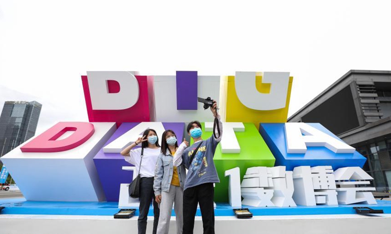 Visitors take a selfie with the logo of the 2021 China International Big Data Expo held in Guiyang, southwest China’s Guizhou Province, May 27, 2021.  Photo: China News Service