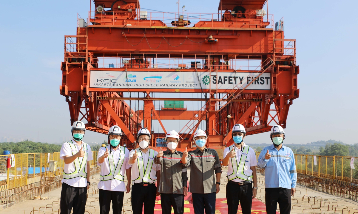 Construction workers pose for a photo at the completion site for the first girder erection channel of the Jakarta-Bandung High Speed Railway on Friday. With a speed of 350 km per hour, the high-speed railway built with Chinese technology will cut the journey between Jakarta and Bandung, the capital of West Java province, from more than three hours to 40 minutes. Photo: cnsphoto