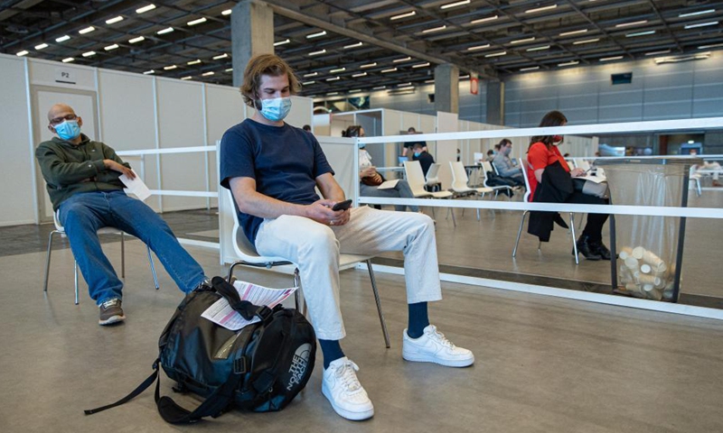 Simon, 25 years old, waits in the observation room after receiving his first dose of COVID-19 vaccine at the Porte de Versailles Exhibition Center in Paris, France, May 28, 2021. All adults over 18 years old can now make an appointment to be vaccinated against COVID-19, the French Health Ministry announced on Thursday.Photo:Xinhua