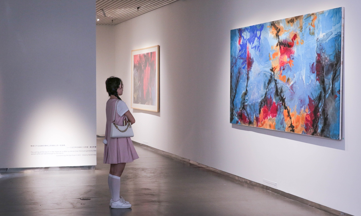 A visitor watch one of art works at the exhibition. Photo: Courtesy of Transfiguration: Shuang Ning New Abstract Works Exhibition 