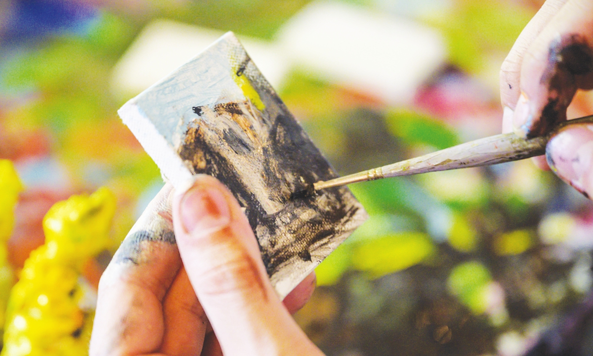 Artist Steve Wasterval works on a mini painting at his studio in the Greenpoint district of the New York borough of Brooklyn on Tuesday. 
Above: A painting by Steve Wasterval Photos: AFP 