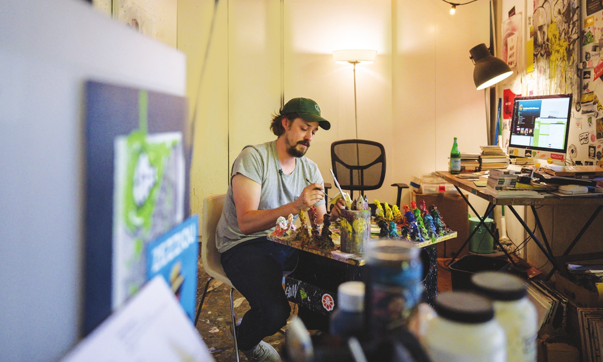 Artist Steve Wasterval works on a mini painting at his studio in the Greenpoint district of the New York borough of Brooklyn on Tuesday. 
Above: A painting by Steve Wasterval Photos: AFP 