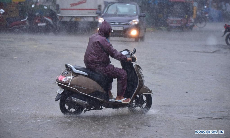 A man rides a scooter in the heavy rain in Nagaon district of India's northeastern state of Assam, May 31, 2021.Photo:Xinhua 