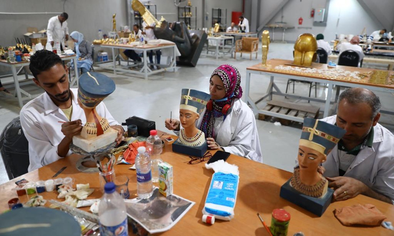 Painters color replicas of ancient Egyptian Queen Nefertiti's bust at Konouz Egypt Replica Treasures in Qalyubia, Egypt, on May 25, 2021. Dozens of designers, sculptors, painters and workers, were busy producing replicas of ancient Egyptian artifacts at Konouz Egypt Replica Treasures, the first factory in Egypt and the Middle East for producing replicas of historical Egyptian antiquities.Photo:Xinhua 