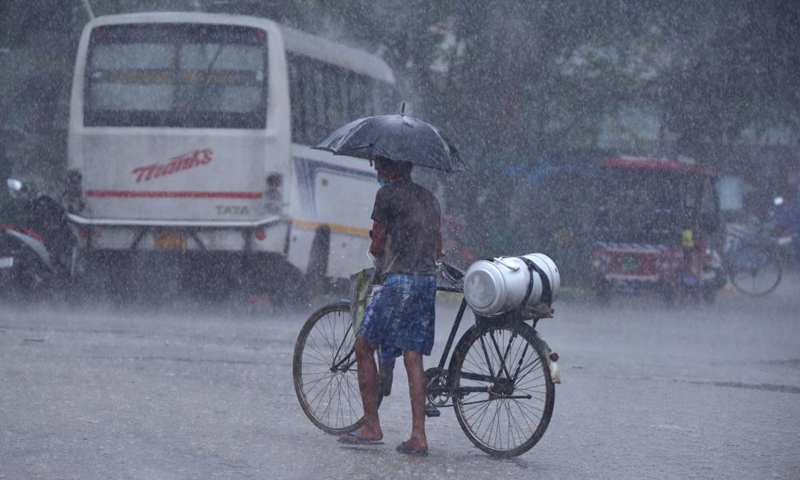A man pushes a bicycle in the heavy rain in Nagaon district of India's northeastern state of Assam, May 31, 2021.Photo:Xinhua 