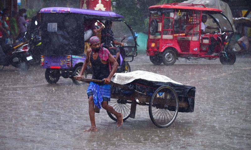 A man pulls a handcart in the heavy rain in Nagaon district of India's northeastern state of Assam, May 31, 2021.Photo:Xinhua 