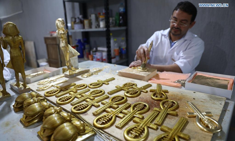 A painter colors a replica of an ancient Egyptian antiquity at Konouz Egypt Replica Treasures in Qalyubia, Egypt, on May 25, 2021. Dozens of designers, sculptors, painters and workers, were busy producing replicas of ancient Egyptian artifacts at Konouz Egypt Replica Treasures, the first factory in Egypt and the Middle East for producing replicas of historical Egyptian antiquities.Photo: Xinhua

