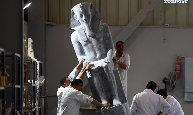 People work on a replica of an ancient Egyptian Pharaonic statue at Konouz Egypt Replica Treasures in Qalyubia, Egypt, on May 25, 2021. Dozens of designers, sculptors, painters and workers, were busy producing replicas of ancient Egyptian artifacts at Konouz Egypt Replica Treasures, the first factory in Egypt and the Middle East for producing replicas of historical Egyptian antiquities.Photo: Xinhua

