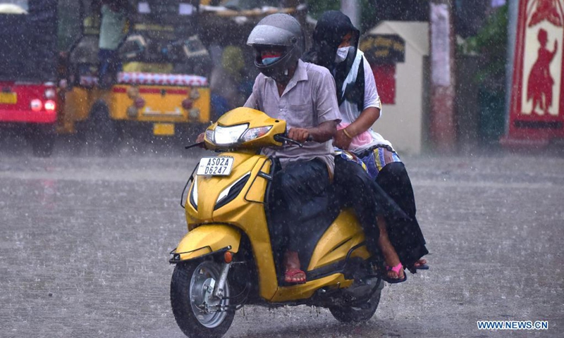 A man rides a scooter in the heavy rain in Nagaon district of India's northeastern state of Assam, May 31, 2021.Photo:Xinhua 