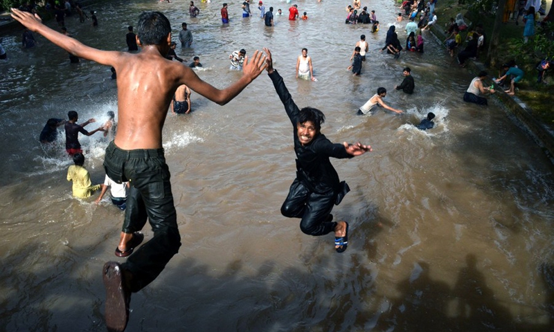 Men jump into a canal to cool themselves in Lahore, capital of Pakistan's Punjab province, on May 30, 2021.(Photo: Xinhua)
