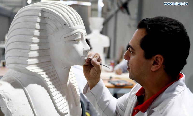 A man works on a replica of a golden mask for an ancient Egyptian mummy at Konouz Egypt Replica Treasures in Qalyubia, Egypt, on May 25, 2021. Dozens of designers, sculptors, painters and workers, were busy producing replicas of ancient Egyptian artifacts at Konouz Egypt Replica Treasures, the first factory in Egypt and the Middle East for producing replicas of historical Egyptian antiquities.Photo: Xinhua

