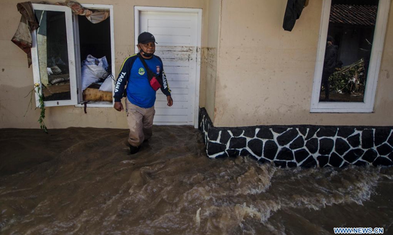 A man walks through floodwaters after a flood in Bandung, West Java, Indonesia, June 2, 2021.(Photo: Xinhua)