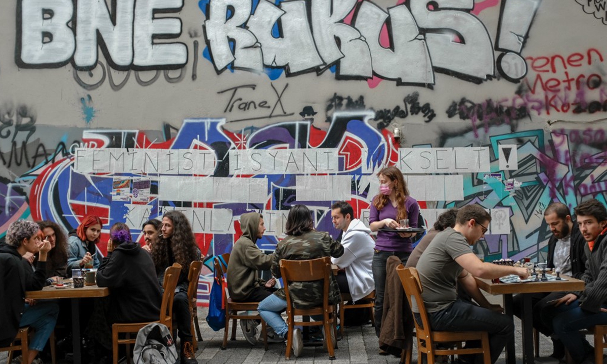 People sit outside a restaurant in Kadikoy neighbourhood, in Istanbul, on Tuesday. Photo: AFP