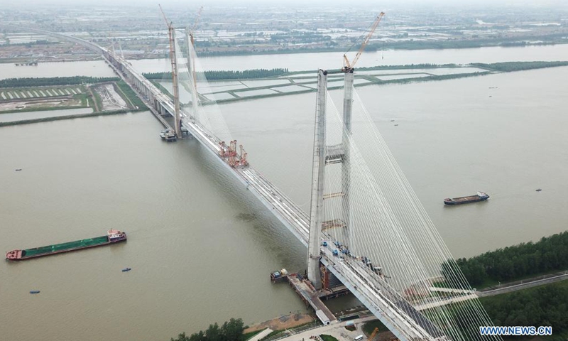Aerial photo taken on June 3, 2021 shows the Bianyuzhou Yangtze River Bridge on the border of central China's Hubei Province and east China's Jiangxi Province. Connecting Huangmei County of central China's Hubei Province and Jiujiang City of east China's Jiangxi Province, the bridge is part of Anqing-Jiujiang Railway.Photo:Xinhua
