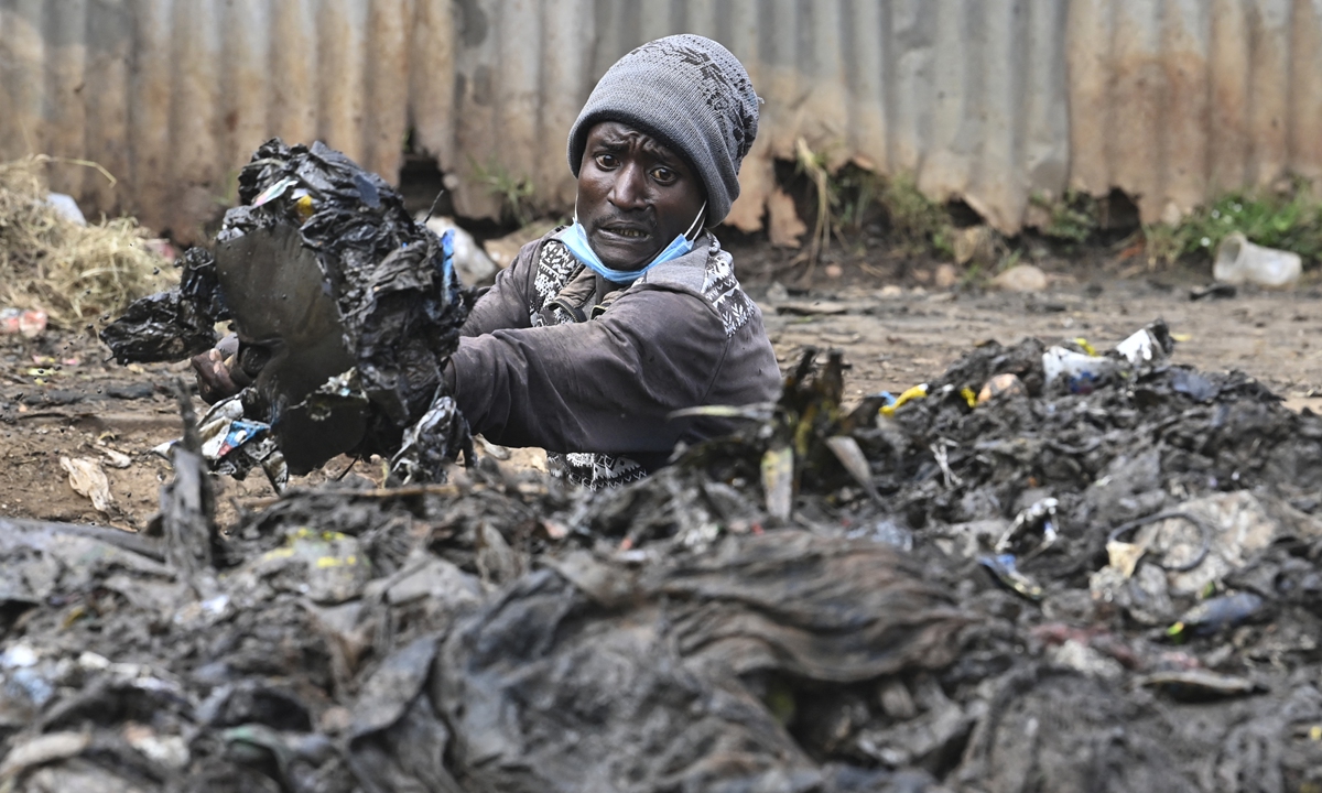 A Kenyan environment activist unclogs drainage ahead of World Environmental Day celebrations in Riruta, Nairobi, on Friday. World Environment Day is the United Nations day to encourage worldwide awareness and action to protect our environment. Photo: AFP