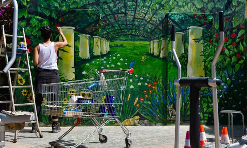 Artist Nathalie Micallef adds the finishing touches to a mural at the Peace Garden in Gharghur, Malta, June 3, 2021. Micallef has spent all her free time since January turning blank walls here into vibrant visuals.Photo: Xinhua