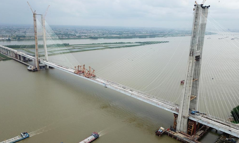 Aerial photo taken on June 3, 2021 shows the Bianyuzhou Yangtze River Bridge on the border of central China's Hubei Province and east China's Jiangxi Province. Connecting Huangmei County of central China's Hubei Province and Jiujiang City of east China's Jiangxi Province, the bridge is part of Anqing-Jiujiang Railway.Photo:Xinhua