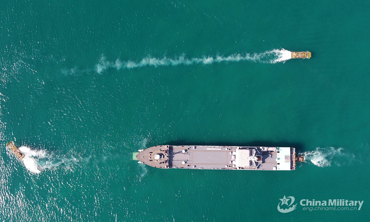 Amphibious armored infantry fighting vehicles (IFVs) steer on and off a landing ship during the several-week-long realistic combat training jointly conducted by a naval landing ship flotilla under the PLA Southern Theater Command and a combined arms brigade under the PLA 74th Group Army in mid-May, 2021.  Photo: China Military Online