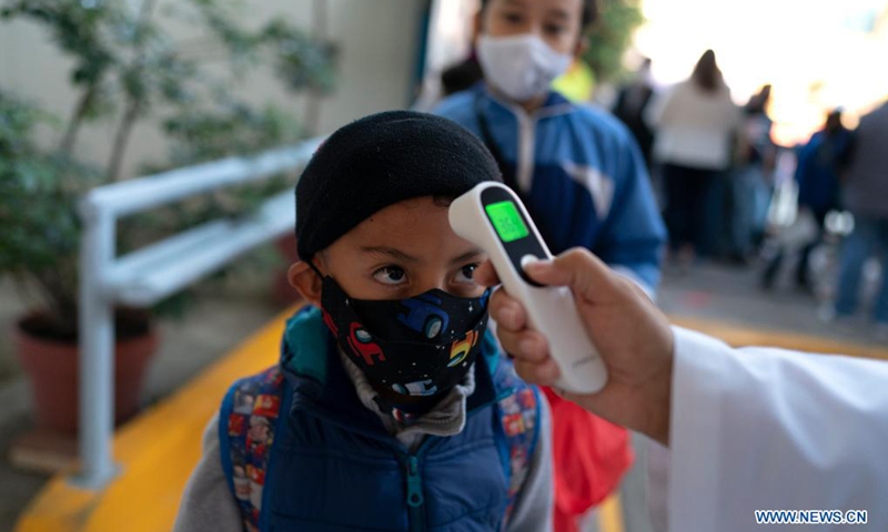 A boy has his temperature checked upon entering an elementary school as in-person classes resume in Mexico City, capital of Mexico, on June 7, 2021.(Photo: Xinhua)